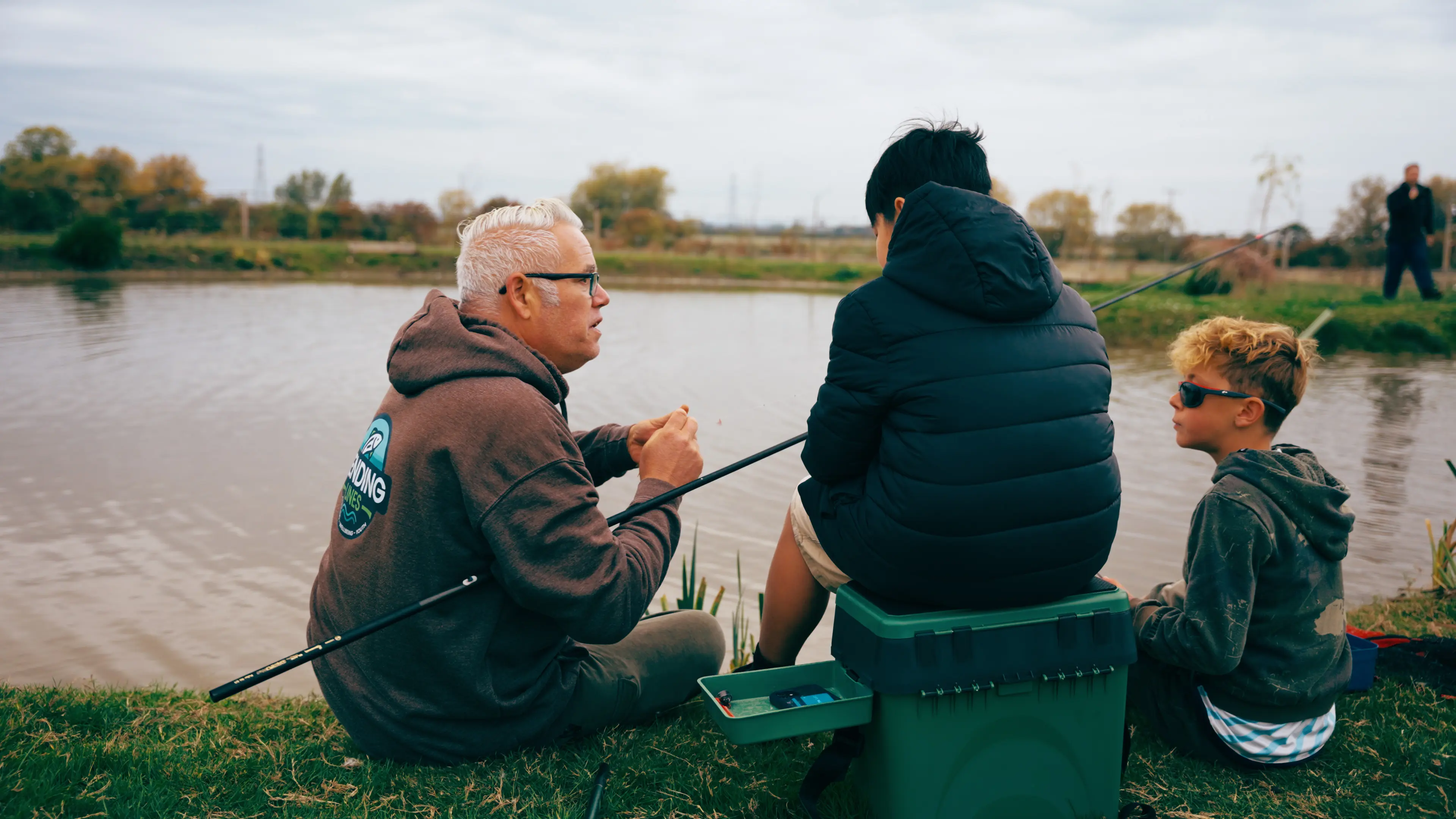 Chris and young anglers on the bank at a Mending Lines session
